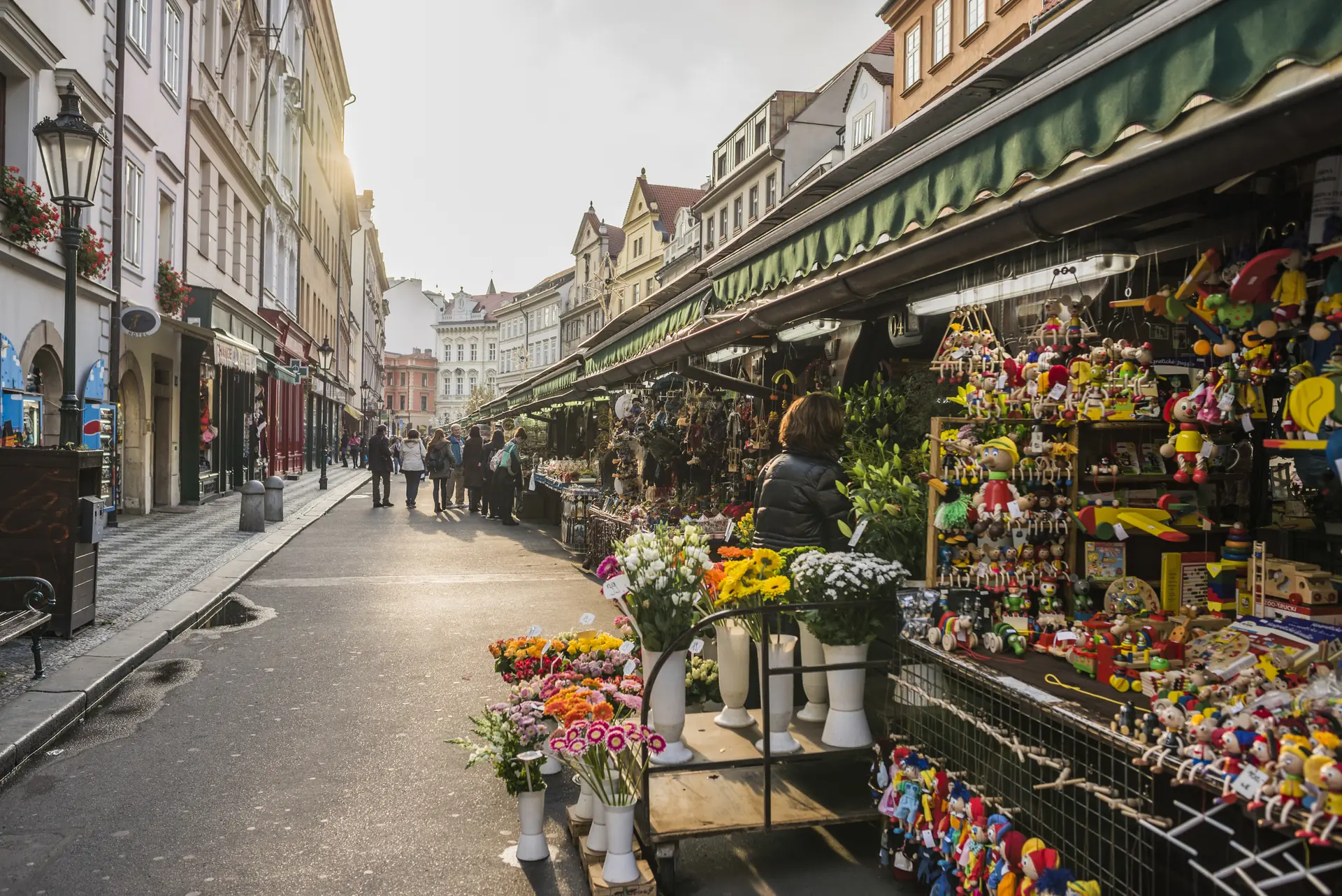 Flower and gift stalls along a busy market street in the run up to Christmas